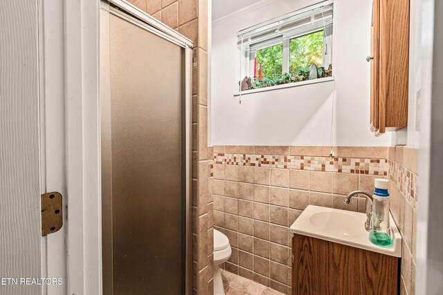314 Longview Dr, Wartburg, TN 37887 - bathroom featuring tile walls, vanity, a shower stall, wainscoting, and ornamental molding