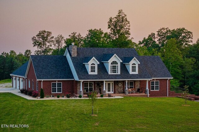3292 Moss Arcott Rd, Celina, TN 38551 - cape cod home with a chimney, a front lawn, and an attached garage