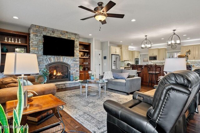 3292 Moss Arcott Rd, Celina, TN 38551 - living area with wood finished floors, a chandelier, a ceiling fan, a fireplace, and recessed lighting