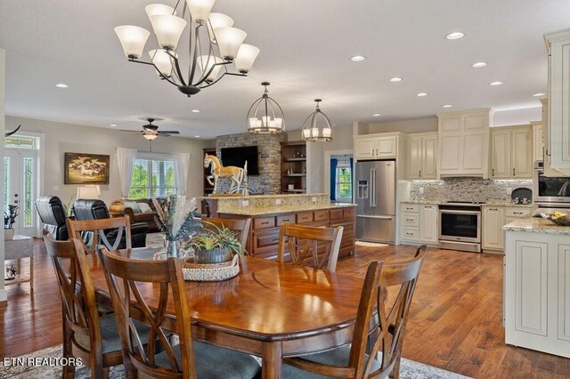 3292 Moss Arcott Rd, Celina, TN 38551 - dining space with a chandelier, recessed lighting, wood finished floors, and a ceiling fan
