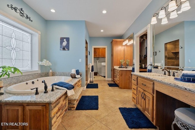 3292 Moss Arcott Rd, Celina, TN 38551 - full bathroom with separate washer and dryer, vanity, tile patterned floors, a bath, and a tile shower