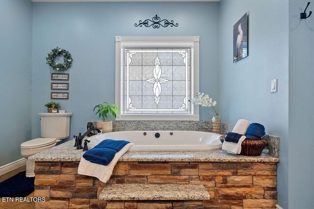 3292 Moss Arcott Rd, Celina, TN 38551 - bathroom with a bath, toilet, and baseboards