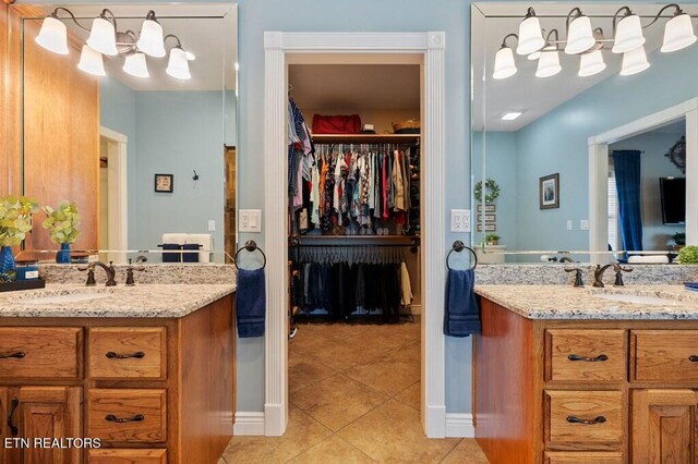 3292 Moss Arcott Rd, Celina, TN 38551 - full bathroom with a chandelier, tile patterned flooring, two vanities, and a walk in closet