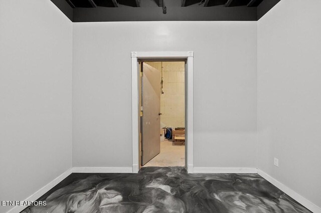 3292 Moss Arcott Rd, Celina, TN 38551 - spare room with baseboards and concrete flooring