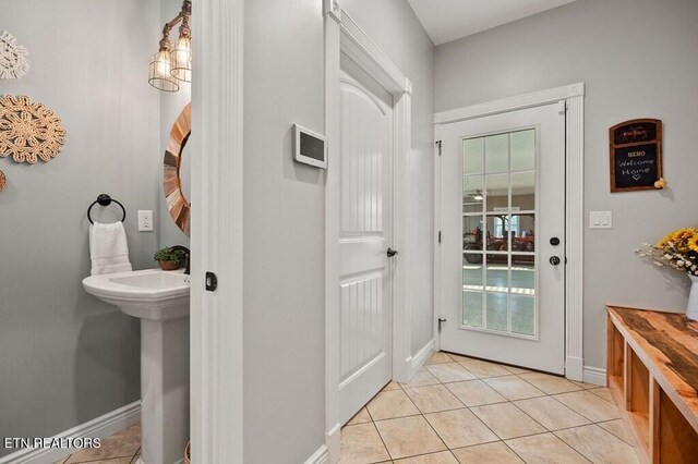 3292 Moss Arcott Rd, Celina, TN 38551 - doorway with light tile patterned flooring, healthy amount of natural light, baseboards, and a sink