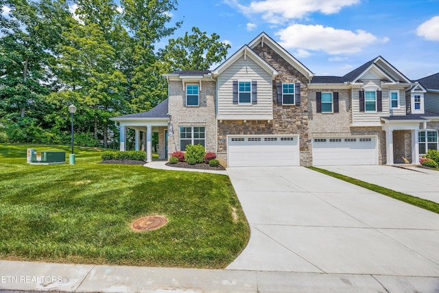 1007 Wigmore Way, Knoxville, TN 37932 - view of front of home with driveway, stone siding, an attached garage, and a front lawn