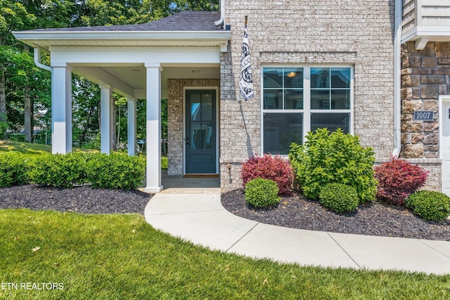 1007 Wigmore Way, Knoxville, TN 37932 - property entrance featuring brick siding, a porch, and a shingled roof