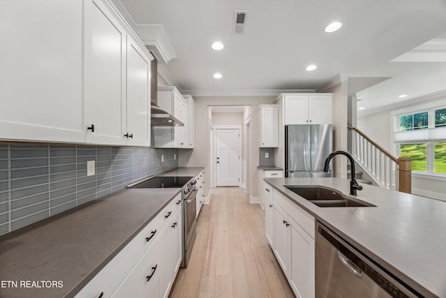1007 Wigmore Way, Knoxville, TN 37932 - kitchen with appliances with stainless steel finishes, crown molding, white cabinets, recessed lighting, and light wood-style flooring