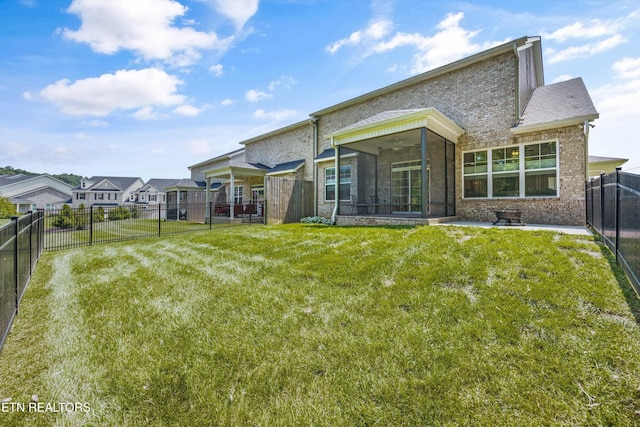 1007 Wigmore Way, Knoxville, TN 37932 - back of house with a sunroom, brick siding, a fenced backyard, and a ceiling fan