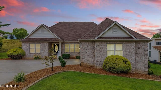 140 Chuniloti Way, Loudon, TN 37774 - view of front of home with a front yard, a shingled roof, and brick siding
