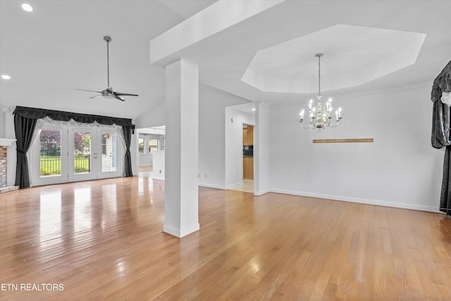 140 Chuniloti Way, Loudon, TN 37774 - unfurnished living room featuring a ceiling fan, light wood finished floors, a chandelier, recessed lighting, and a tray ceiling