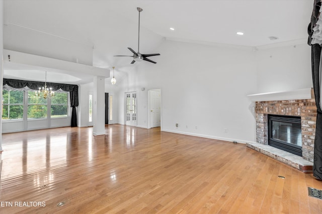 140 Chuniloti Way, Loudon, TN 37774 - unfurnished living room featuring a fireplace, a ceiling fan, a chandelier, light wood finished floors, and high vaulted ceiling