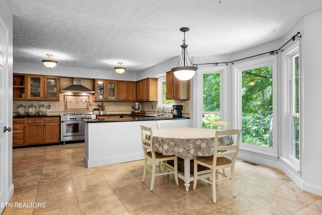 1312 Zachary Taylor Rd, Knoxville, TN 37922 - kitchen featuring double oven range, wall chimney range hood, dark countertops, tasteful backsplash, and brown cabinetry