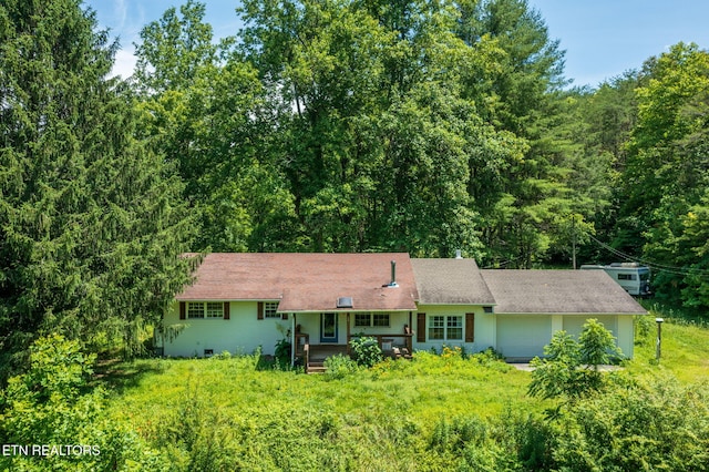 775 Middle Creek Rd, Cosby, TN 37722 - view of front of house featuring a garage, covered porch, and a forest view