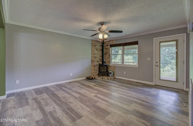 775 Middle Creek Rd, Cosby, TN 37722 - unfurnished living room with a wood stove, a textured ceiling, ceiling fan, wood finished floors, and ornamental molding