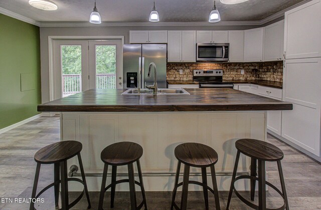 775 Middle Creek Rd, Cosby, TN 37722 - kitchen with stainless steel appliances, wood counters, tasteful backsplash, crown molding, and pendant lighting