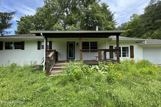 775 Middle Creek Rd, Cosby, TN 37722 - view of front facade featuring a porch, an attached garage, and brick siding