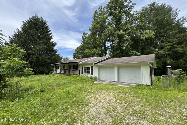 775 Middle Creek Rd, Cosby, TN 37722 - view of grassy yard featuring covered porch and a garage