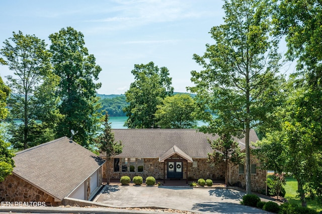 226 Mountain Crest Dr, Lafollette, TN 37766 - view of front of property featuring stone siding, roof with shingles, and concrete driveway