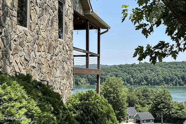 226 Mountain Crest Dr, Lafollette, TN 37766 - exterior view of stone siding and nearby water