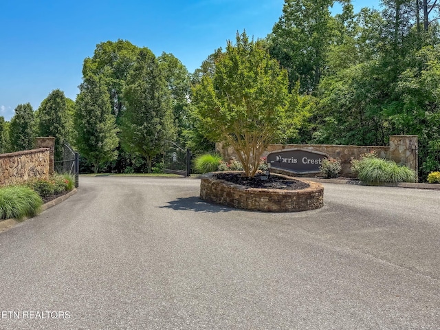 226 Mountain Crest Dr, Lafollette, TN 37766 - view of asphalt road with a gated entry and curbs