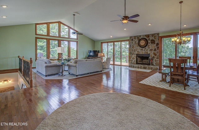 226 Mountain Crest Dr, Lafollette, TN 37766 - living area with ceiling fan, hardwood / wood-style floors, vaulted ceiling, a fireplace, and a chandelier