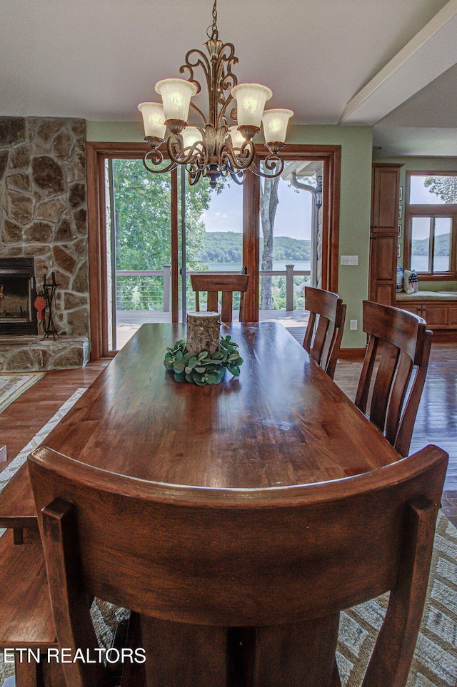 226 Mountain Crest Dr, Lafollette, TN 37766 - dining room with wood finished floors, a chandelier, and a fireplace