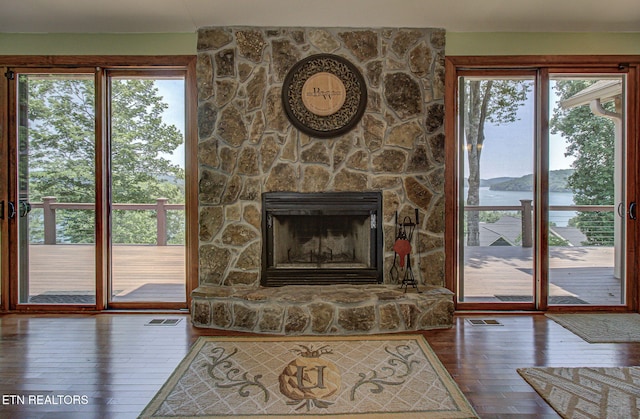 226 Mountain Crest Dr, Lafollette, TN 37766 - living room featuring dark wood-style flooring, a water view, and a fireplace