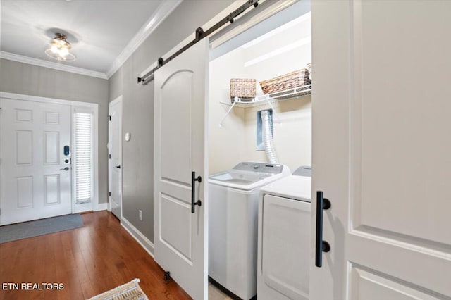 140 Broadleaf Ln Unit 100, Caryville, TN 37714 - laundry area with a barn door, washing machine and clothes dryer, wood finished floors, and ornamental molding