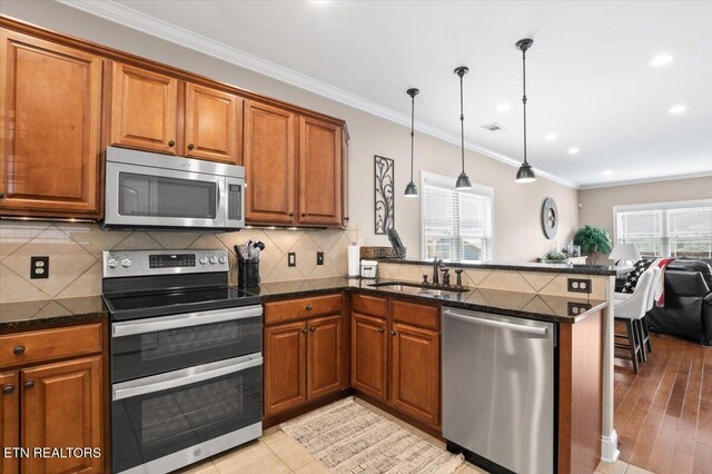 140 Broadleaf Ln Unit 100, Caryville, TN 37714 - kitchen featuring stainless steel appliances, brown cabinets, ornamental molding, and recessed lighting