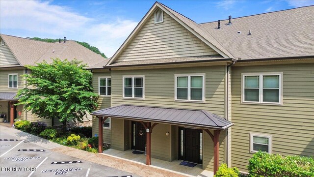 140 Broadleaf Ln Unit 100, Caryville, TN 37714 - view of front of property with a porch, uncovered parking, and a metal roof