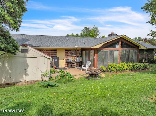 3413 N Fountaincrest Dr, Knoxville, TN 37918 - back of property with a storage shed, a fire pit, a patio area, a yard, and brick siding