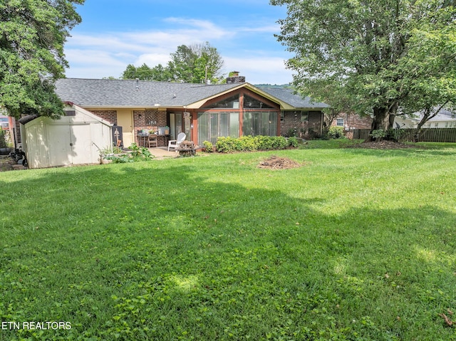3413 N Fountaincrest Dr, Knoxville, TN 37918 - rear view of property featuring a storage unit, a patio area, brick siding, a chimney, and a sunroom