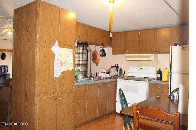 2122 Pickett Park Hwy, Jamestown, TN 38556 - kitchen with white appliances, under cabinet range hood, ceiling fan, light wood finished floors, and brown cabinets