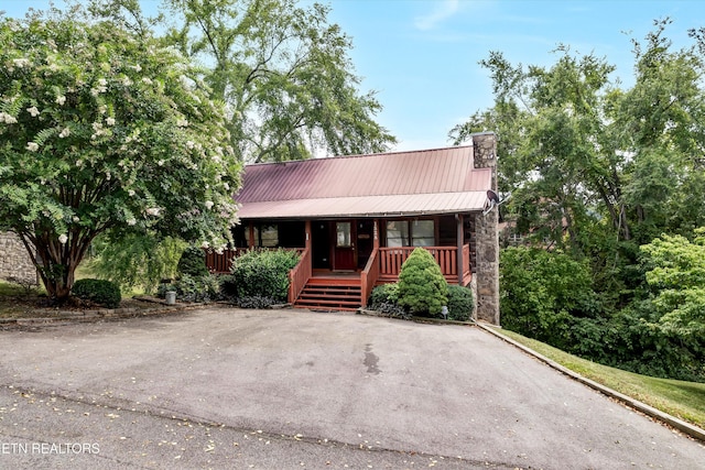 1528 Rainbow Ridge Way, Sevierville, TN 37862 - rustic home with covered porch, a chimney, stone siding, and a metal roof