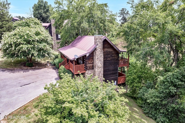 1528 Rainbow Ridge Way, Sevierville, TN 37862 - view of property exterior featuring a chimney, a metal roof, log exterior, and a deck