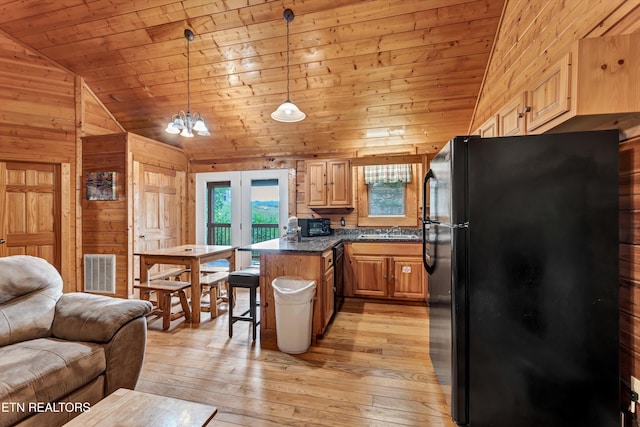 1528 Rainbow Ridge Way, Sevierville, TN 37862 - kitchen featuring black appliances, lofted ceiling, wood walls, wooden ceiling, and open floor plan