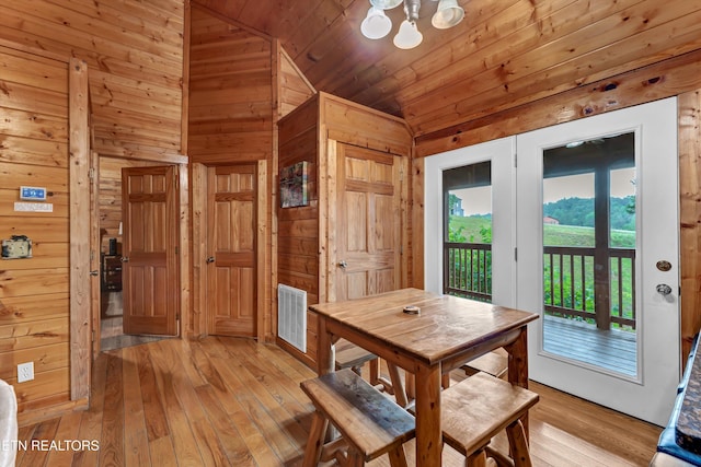 1528 Rainbow Ridge Way, Sevierville, TN 37862 - dining room featuring lofted ceiling, light wood-style flooring, wooden walls, a chandelier, and wooden ceiling