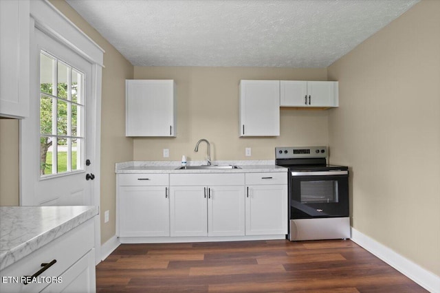 715 E Kentucky Ave, Lafollette, TN 37766 - kitchen featuring stainless steel range with electric cooktop, dark wood-style floors, white cabinets, light countertops, and a textured ceiling