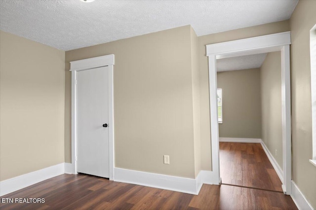 715 E Kentucky Ave, Lafollette, TN 37766 - unfurnished bedroom featuring dark wood-type flooring and a closet