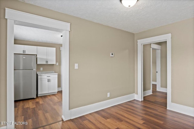 715 E Kentucky Ave, Lafollette, TN 37766 - spare room with dark wood-style floors and a textured ceiling