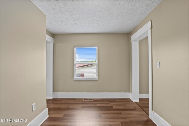 715 E Kentucky Ave, Lafollette, TN 37766 - empty room featuring wood finished floors and a textured ceiling