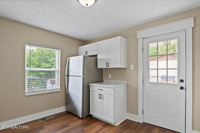 715 E Kentucky Ave, Lafollette, TN 37766 - kitchen featuring freestanding refrigerator, dark wood-style floors, plenty of natural light, white cabinetry, and a textured ceiling