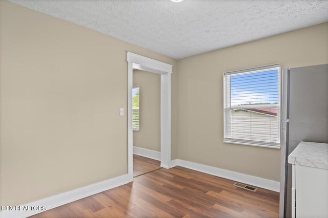 715 E Kentucky Ave, Lafollette, TN 37766 - spare room featuring wood finished floors and a textured ceiling