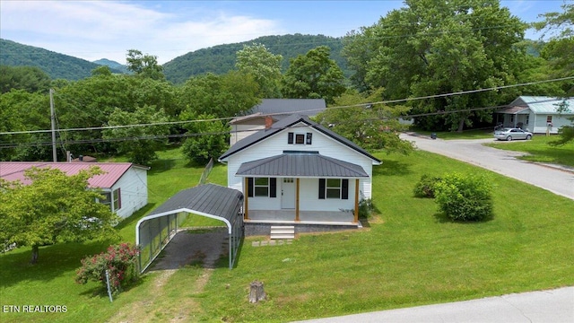 715 E Kentucky Ave, Lafollette, TN 37766 - bungalow-style home featuring covered porch, a carport, and a front lawn