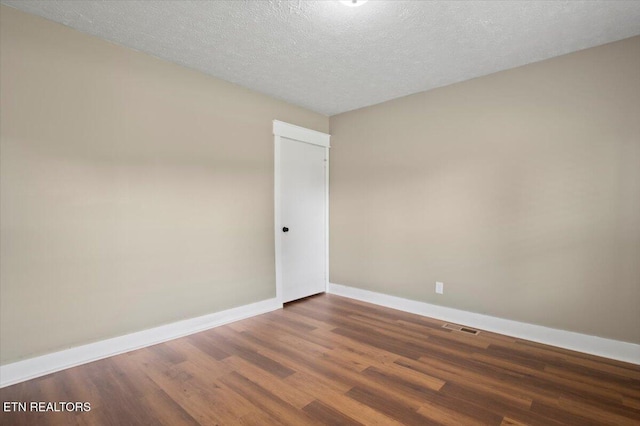 715 E Kentucky Ave, Lafollette, TN 37766 - spare room featuring wood finished floors and a textured ceiling