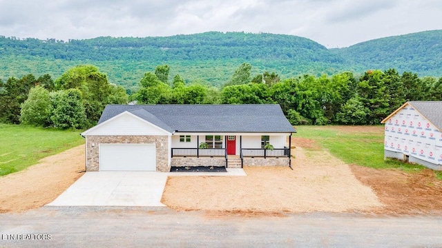 132 Galloway Airport Rd, Dunlap, TN 37327 - view of front of home with a porch, an attached garage, driveway, and a forest view