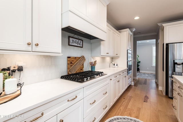 11914 Sandy Run Rd, Knoxville, TN 37934 - kitchen featuring stainless steel appliances, ornamental molding, white cabinets, light wood-type flooring, and light countertops