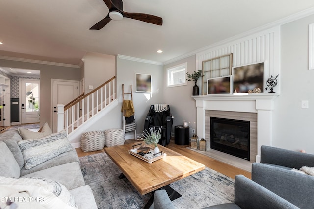 11914 Sandy Run Rd, Knoxville, TN 37934 - living room with ornamental molding, a ceiling fan, stairs, a glass covered fireplace, and wood finished floors