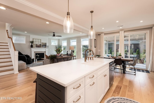 11914 Sandy Run Rd, Knoxville, TN 37934 - kitchen with crown molding, an island with sink, decorative light fixtures, light wood finished floors, and white cabinets